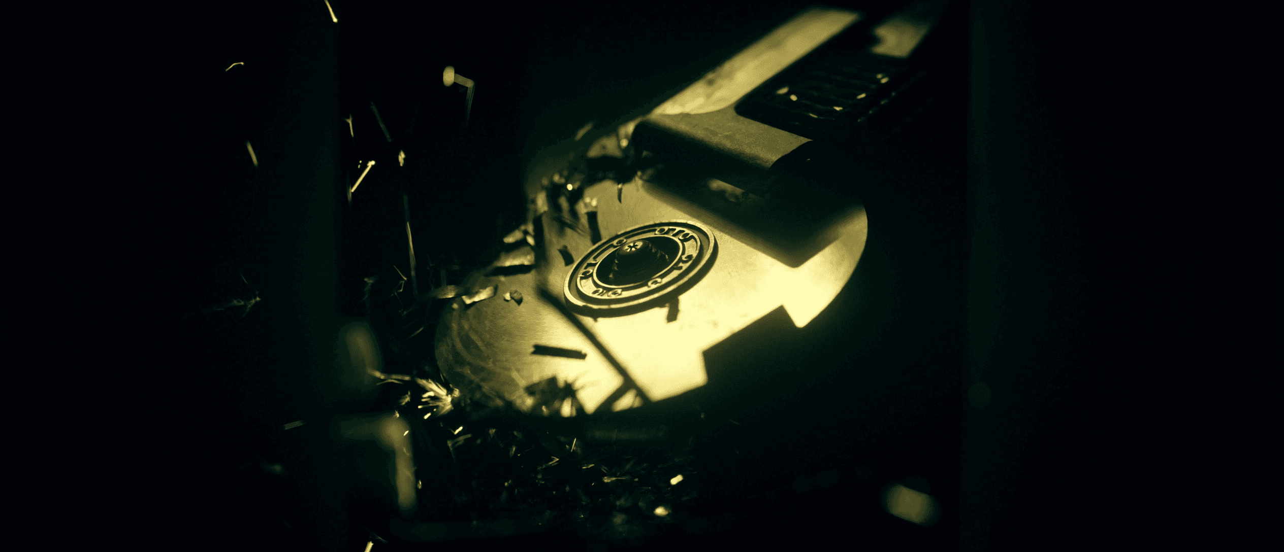 Cinematic close-up of a hard drive being physically destroyed